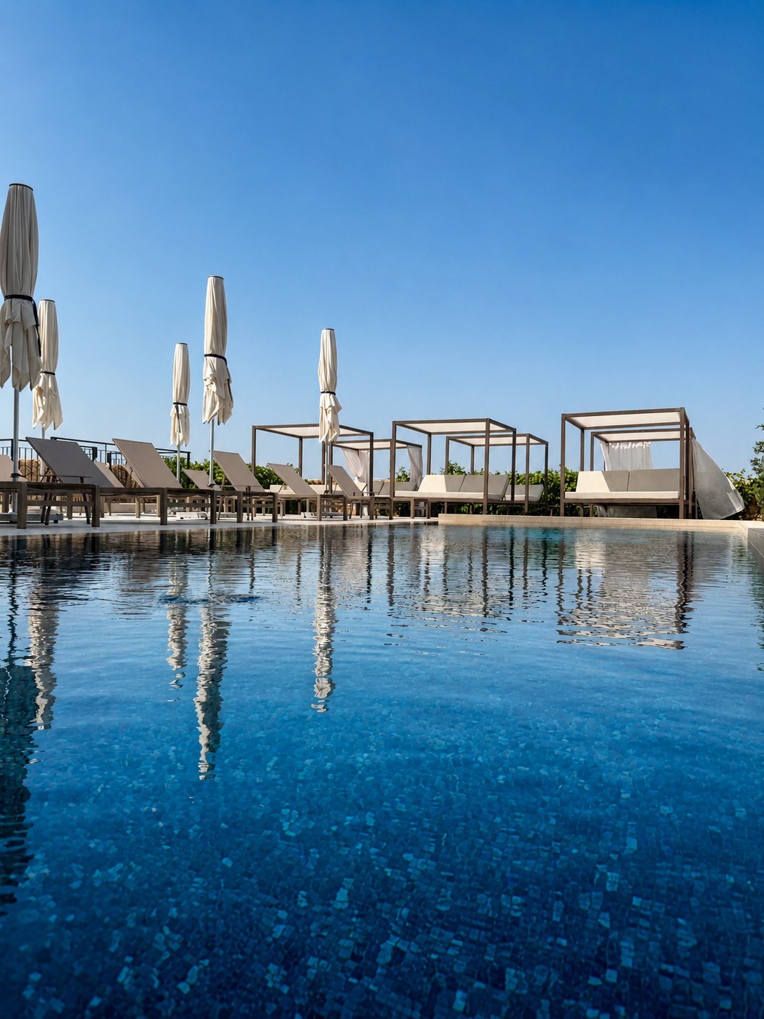 Outdoor pool and private cabanas at Quaint Signature Hotel