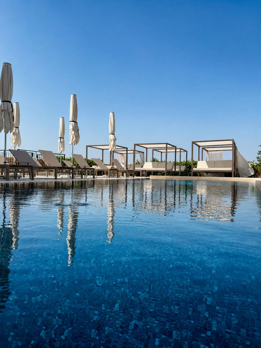 Outdoor pool and private cabanas at Quaint Signature Hotel